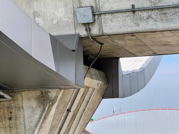 一架飞机飞过一座桥的照片，背景是天空。图片下载