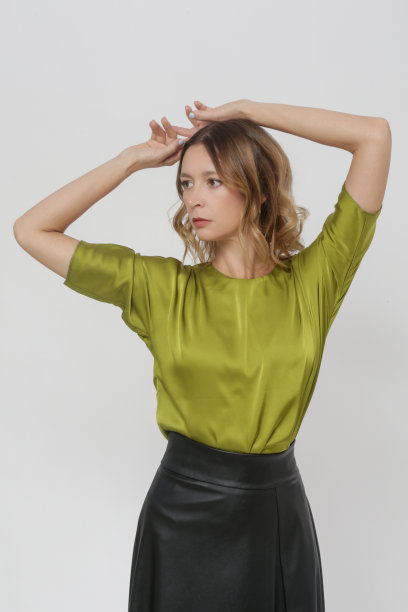 一系列的工作室照片的女模特丝绸绿色衬衫和黑色皮革中长裙图片下载