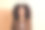 照片中，一个长着牙齿、笑容灿烂的乐观女孩，穿着棕色衬衫，烫发，在柔和的背景下对着相机微笑图片下载