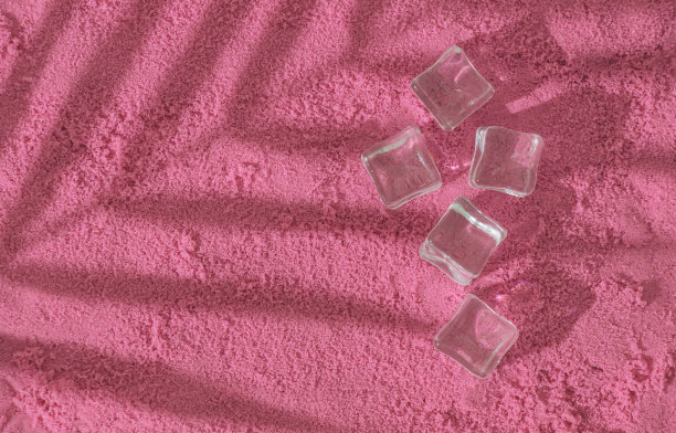 热带棕榈树的叶子阴影和冰块在粉红色的沙滩背景。夏日的审美观念。暑假的最小概念照片。太阳和阴影。创意文案空间。异国情调的平地。图片下载