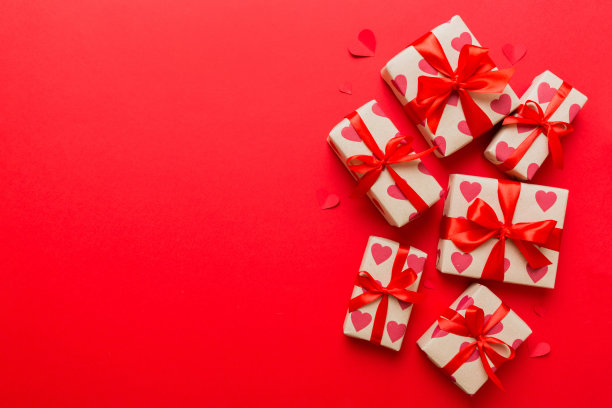 情人节装饰礼盒与红丝带蝴蝶结彩色背景的俯视图照片。假日礼盒与顶视图图片下载