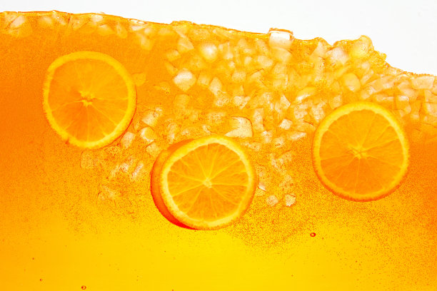 变形的照片。节日安排柑橘类水果，橙片皇冠庆祝饮料。抽象的壁纸。图片下载