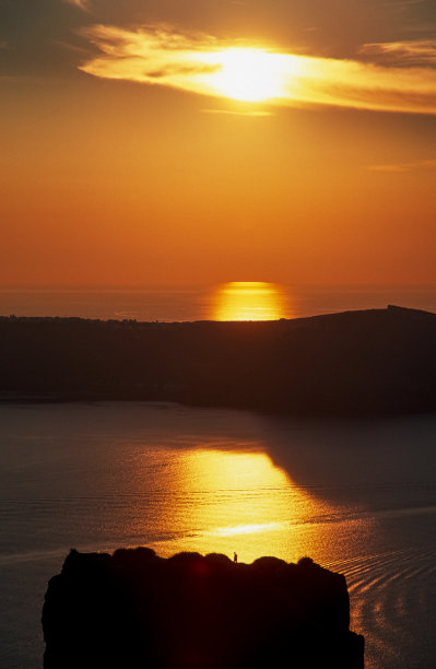 扫描幻灯片的历史彩色照片的日落或日出在火山口的圣都灵与岩石上的一个人的剪影图片下载