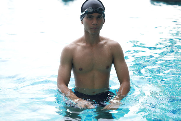 亚洲男人练习游泳和马球，伸展和休息的水上运动。图片下载
