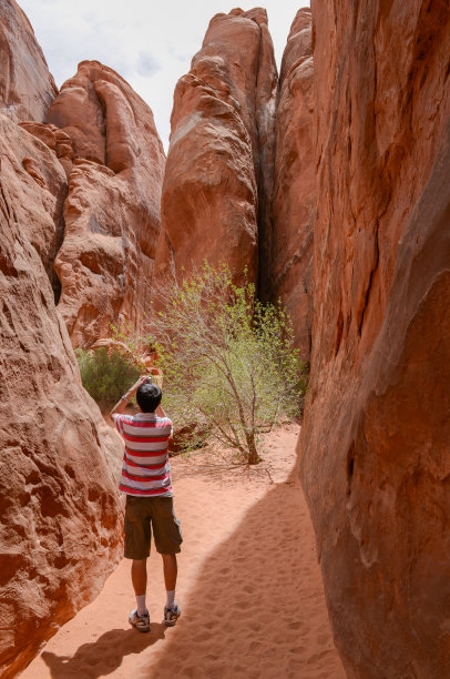 游客在拱门国家公园拍摄峡谷照片。犹他州。美国。图片下载