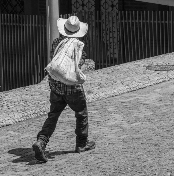 一位哥伦比亚农民走在街上，头戴一顶典型的安蒂奥基亚帽子，背上背着一个袋子。漂亮的黑白照片。杰瑞科,杰瑞科;安蒂奥基亚省、哥伦比亚。图片下载