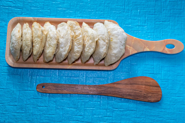 近距离照片新鲜排灯节小吃或faral项目在一个盘子与明确的蓝色背景。图片下载