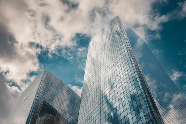 低角度视图的玻璃摩天大楼在纽约市与天空中的云-股票照片图片下载