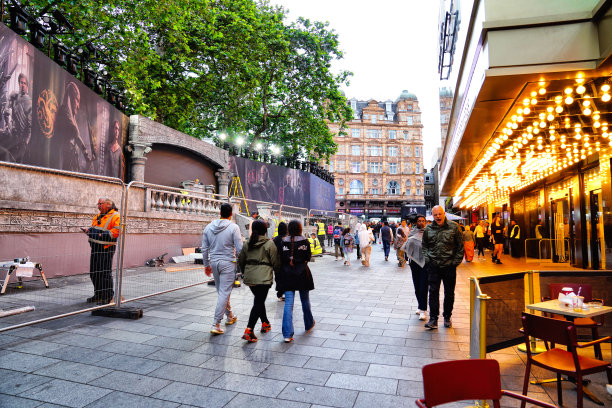 在英国伦敦市中心的莱斯特广场，游客们在奥登杜比豪华电影院门口观看《龙之屋》第二季图片下载