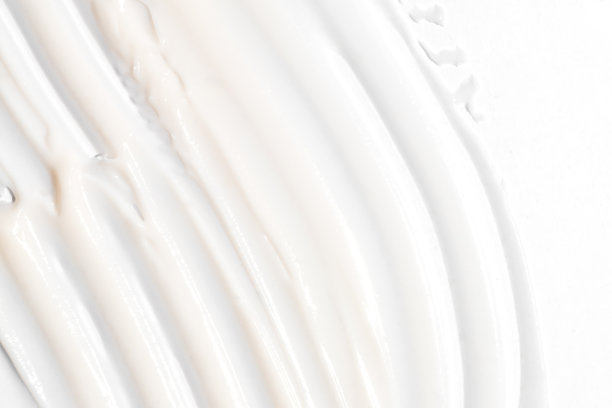 美容霜的质地。白色乳液，保湿霜，护肤化妆品的应用背景。图片下载