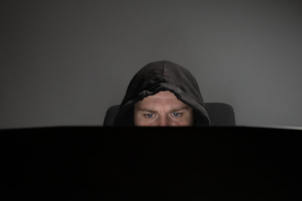 黑客，带笔记本电脑的人，戴兜帽的人，网络跟踪狂，网络威胁。图片下载