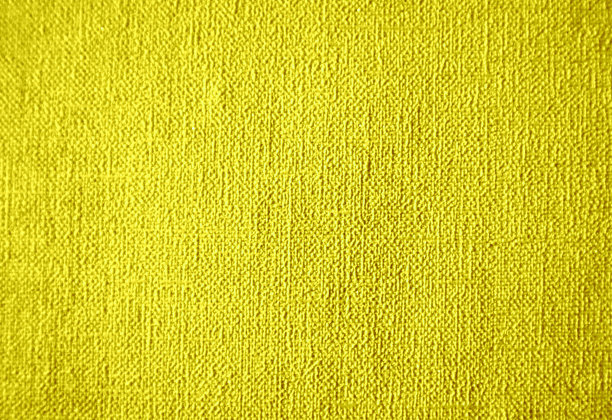 照片明亮的黄色纹理背景。小点和线的纹理。织物，墙纸，材料。图片下载