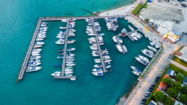 俯瞰宁静的加尔达湖码头与停靠在意大利的帆船在晚上。意大利，Peschiera del Garda股票照片图片下载