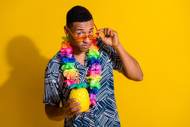 照片时髦可疑的家伙穿着印花衬衫花配件喝鸡尾酒看你孤立的黄色背景图片下载