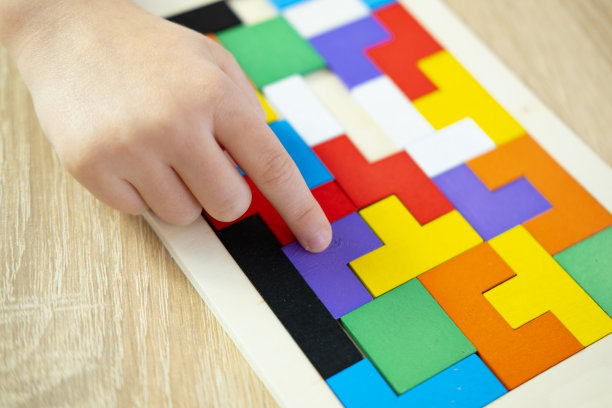 孩子的手探索复杂的世界五颜六色的木制拼图，培养创造力、想象力和解决问题的能力图片下载