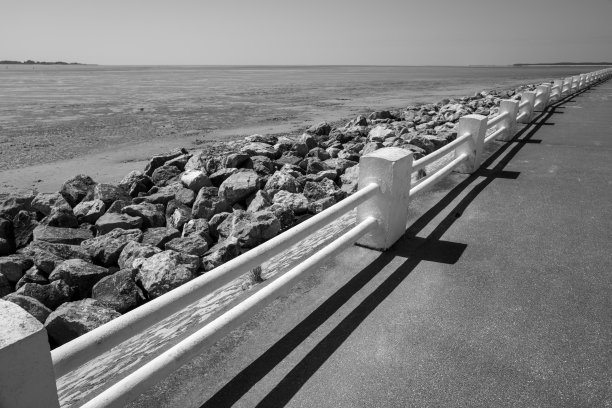 法国北部勒克罗托伊海岸公路上的白色栏杆，灰阶照片图片下载