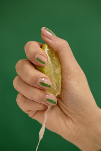 女人用手挤半个多汁的柠檬图片下载