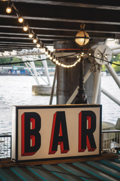 白色背景上的红色和黑色字母的老式标志，上面有一排灯泡灯。图片下载