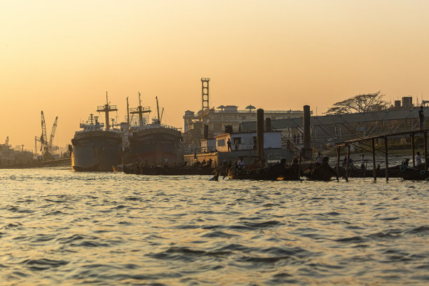 日落时分，吉大港的船只在水面上图片下载