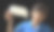 一个可爱的、微笑的、快乐的11岁男孩的横向照片，他穿着休闲的蓝色polo t恤，手里拿着一个纸工艺品，剪纸的形状是一个空白的、空的演讲泡泡或呼叫，向下指着自己，孤立在黑色的背景上图片下载