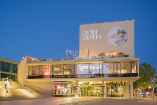 柏林比基尼购物中心和德皇威廉纪念教堂在动物园花园地铁站的夜晚图片下载