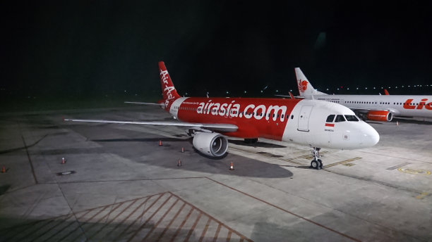 亚洲航空公司和狮子航空公司的飞机停在印度尼西亚龙目岛中部的龙目岛国际机场图片下载