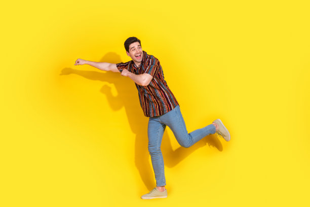 漂亮的年轻人跳舞的全尺寸照片欢乐穿衬衫孤立的黄色背景图片下载