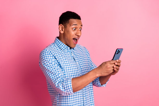 时髦印象深刻的家伙穿着格子衬衫得到按摩现代设备的空白空间孤立的粉红色背景的照片图片下载