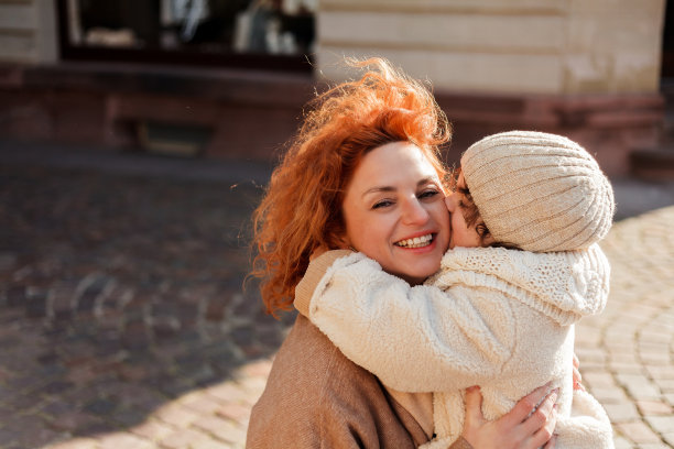 美丽的年轻母亲和可爱的4岁小女儿走在老城的中心。欧洲。幸福的家庭。图片下载