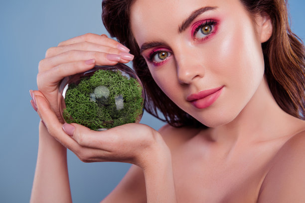 特写照片的女人粉红色改造持有玻璃手套绿色植物隔离灰色背景图片下载