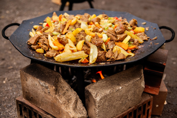 户外烹饪:传统的牛肉和蔬菜炒图片下载