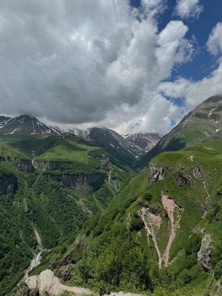 垂直照片的全景绿色高加索山脉与多云的天空图片下载