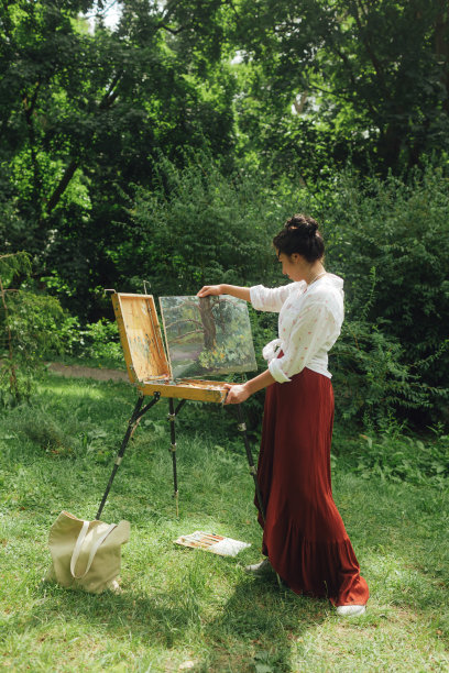 女艺术家在公园里画画。正念，艺术疗法，创意概念。在大自然中进行空气绘画的过程。一系列的照片展示了一幅画的一步一步的创作图片下载