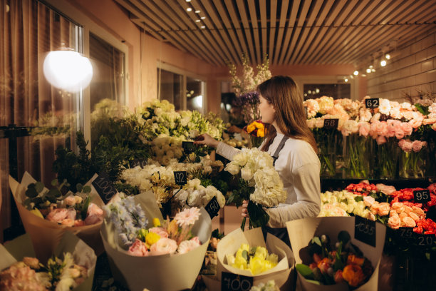 女花商在她自己的花店照顾鲜花图片下载