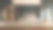 木制桌面在模糊的厨房房间背景，展示了一个现代和时尚的厨房设计与深色橱柜- 3D渲染图片下载