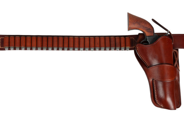 古老的西部武器。皮制枪带，枪套内装有弹药和左轮手枪图片下载