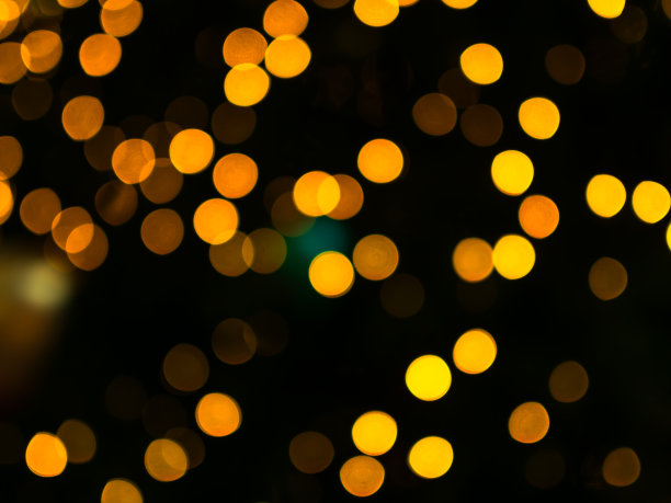背景散景黄灯温暖的节日闪耀金色抽象庆祝圣诞新年贺卡派对照片，闪光圈橙色发光图案夜魅力迪斯科背景。图片下载