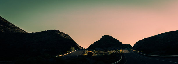 在夕阳的余晖下，美国乡村两条山间高速公路的全景照片图片下载