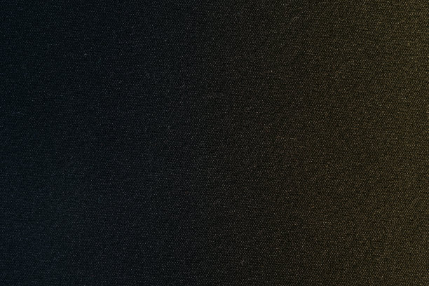 暗黑色纹理背景织物材料背景壁纸表面略带渐变的蓝色和黄色的颜色图片下载