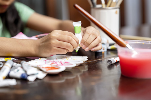 一个小女孩用画笔和水彩画图片下载