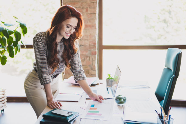 迷人的好心情的女ceo穿着正式的衬衫拿着文件在室内工作场所工作站阁楼的照片图片下载