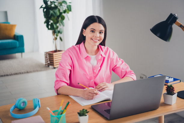 漂亮开朗的女士穿着粉色衬衫的照片，远程教育室内的现代小玩意图片下载