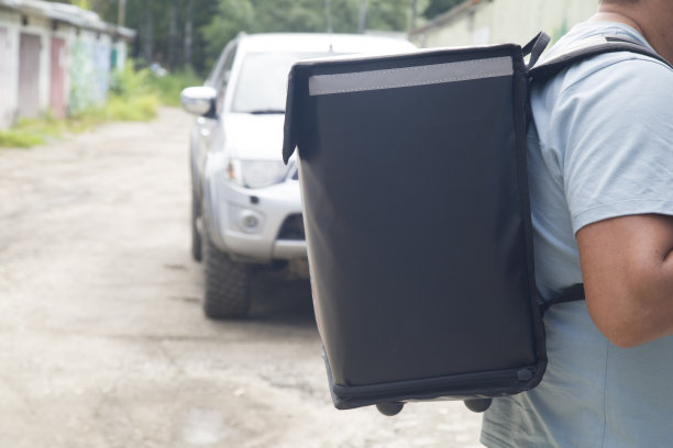 送餐上门。一个带着特殊背包的快递员。图片下载