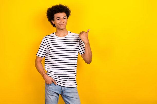 照片的年轻人chevelure头发直接手指新奇穿条纹t恤表明市场折扣孤立的黄色背景图片下载