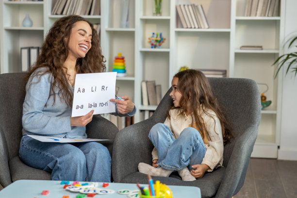 长发女语言治疗师向一个长发小病人展示图片图片下载