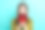 照片中可爱可爱的女人穿着条纹开衫尖叫着牛角孤立的蓝绿色背景图片下载