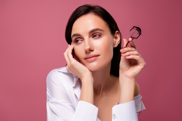 女孩的照片感觉梦想看起来粉红色的颜色空白空间背景持有睫毛夹图片下载
