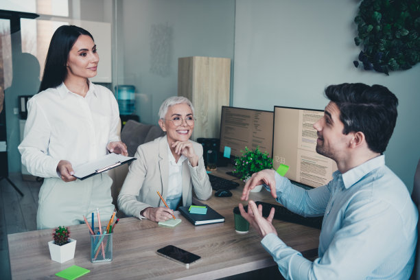 三位商务人士在现代工作场所开会讨论的照片图片下载