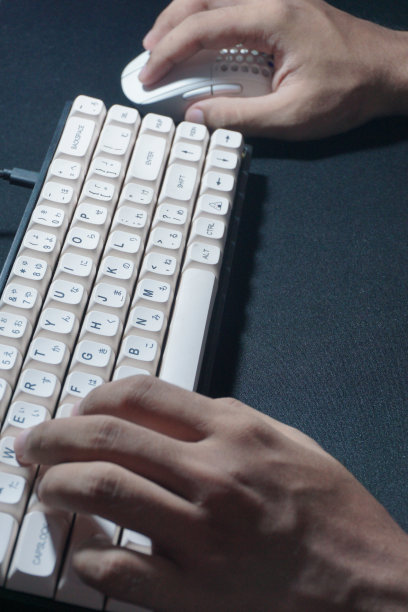 一个男人用键盘和鼠标操作电脑的特写镜头图片下载