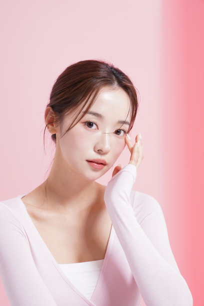 一个年轻女子在粉红色背景下拍摄的漂亮肖像图片下载